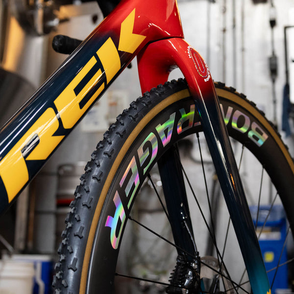 Trek gravel bike with holographic custom wheel vinyl decal of Bontrager logo