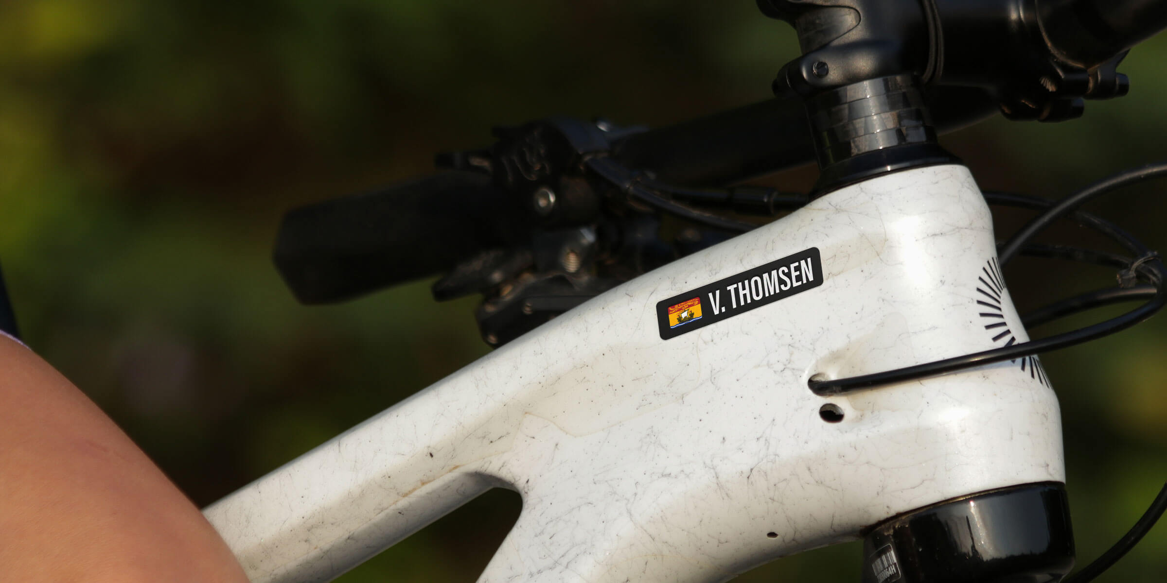 Close up of a New Brunswick name bar decal on a white mountain bike frame