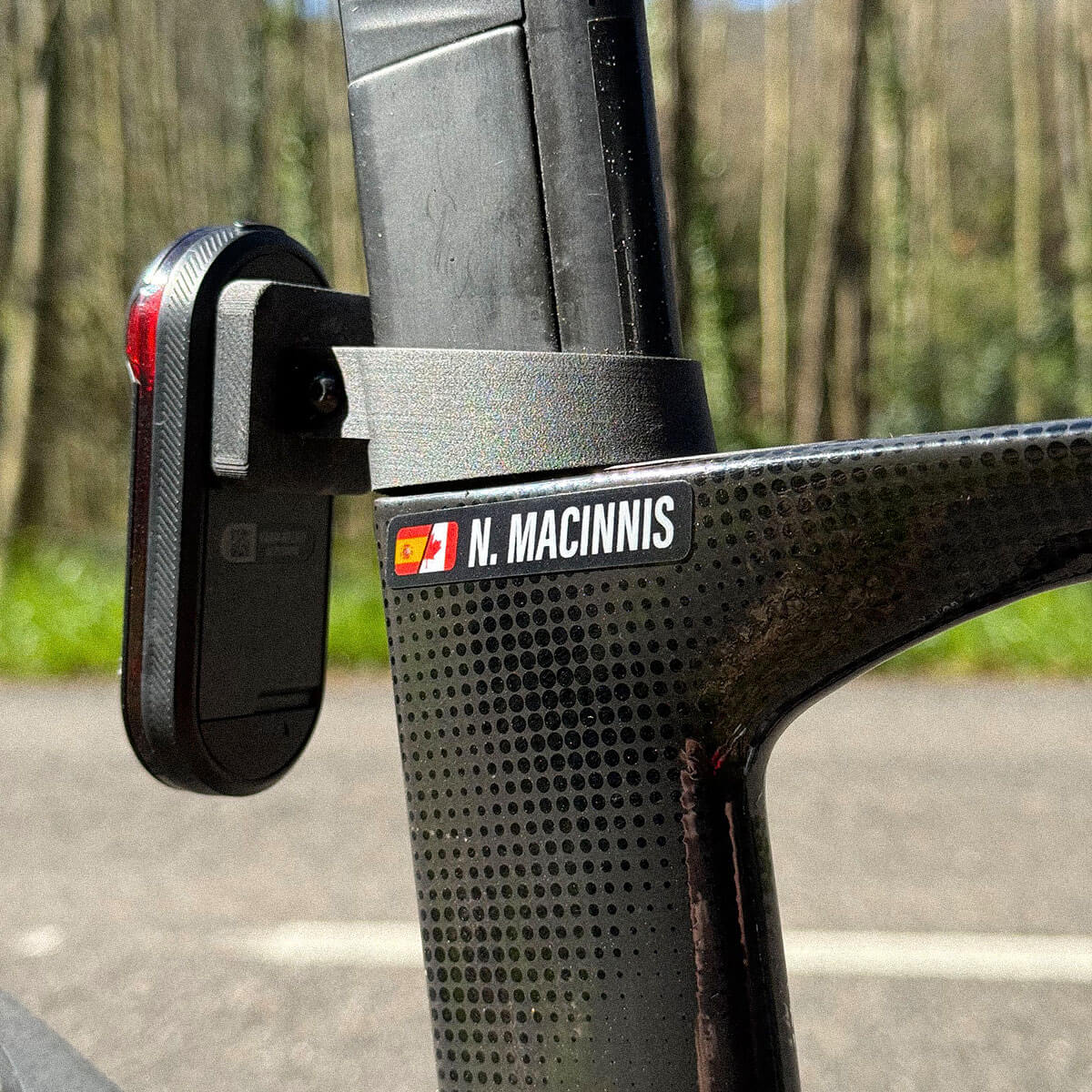 A close up shot of a split flag namebar decal with Canada and Spain flags